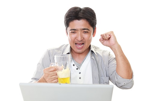 Man Drinking Beer at Laptop