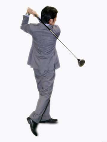 Lawyer in suit playing golf